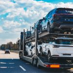 Car transport truck driving on highway road. Car Carrier Trailer on asphalt road